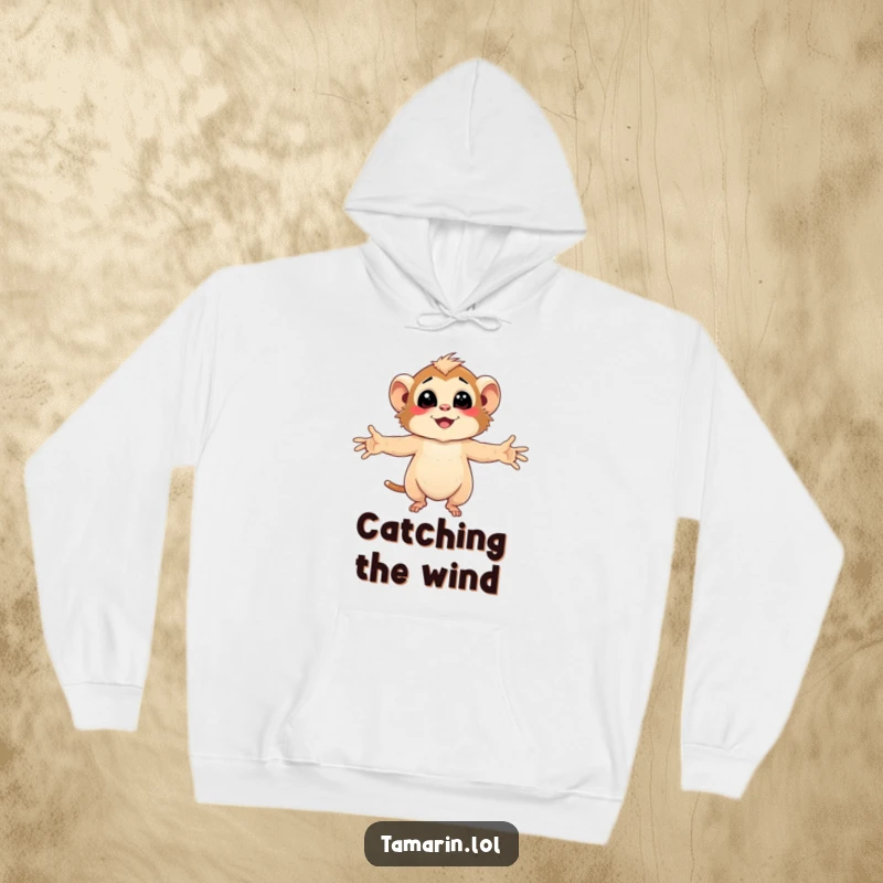 Funny Tamarin Hoodie with character embracing the gentle, smiling breeze with arms wide open, feeling cozy.