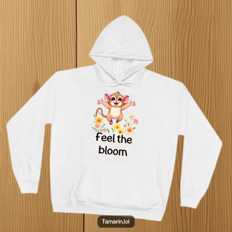 Funny hoodie showing a tamarin with arms wide open, leaping through colorful flowers, offering cozy and humorous animal vibes.