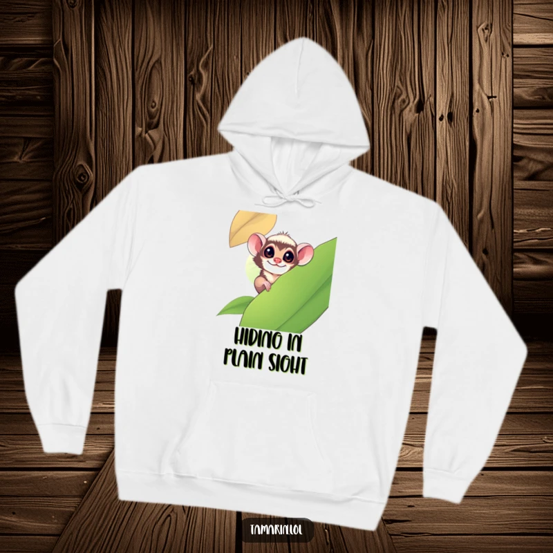 Funny tamarin monkey playfully peeking from behind a large leaf, depicted on a soft and warm hoodie.