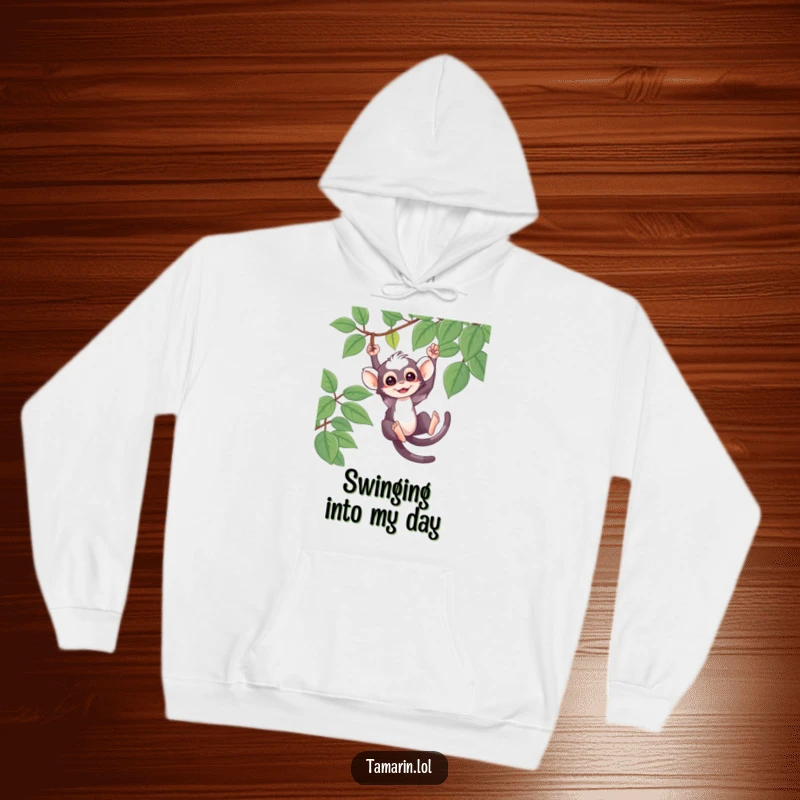 Funny Hoodie featuring a cute tamarin character swinging from a vine, showcasing playful jungle antics.