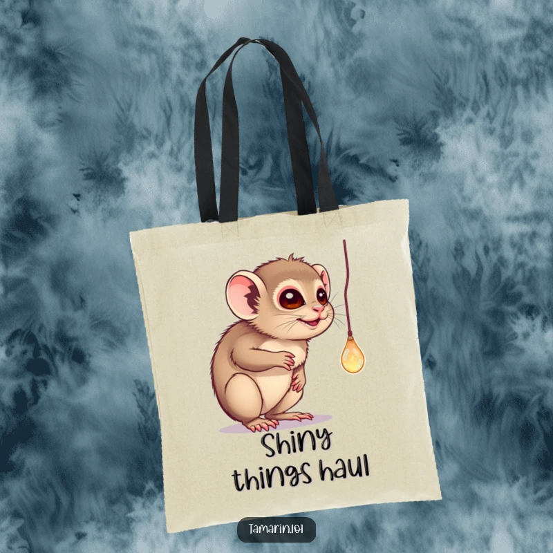 Funny tote bag featuring a tamarin batting playfully at a dangling, sparkling object, perfect for stylish, humorous shopping.